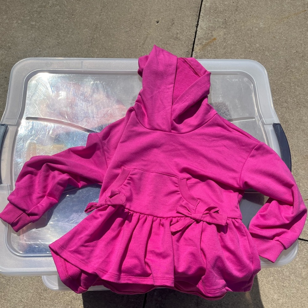 Girls pink shirt with a hood brand name is Habitual